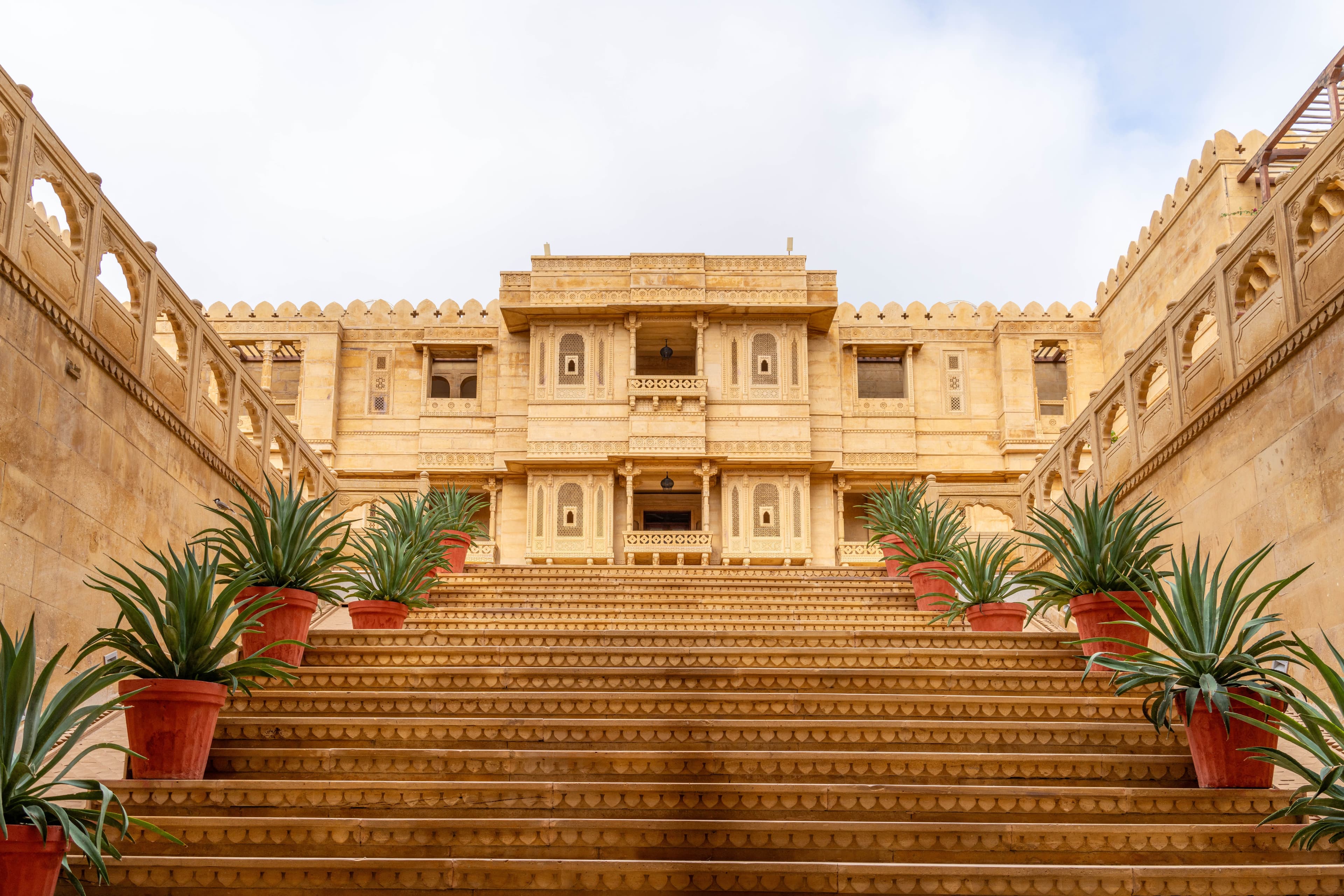 Majestic fort-turned-heritage hotel with sandstone walls and ornate balconies in Rajasthan