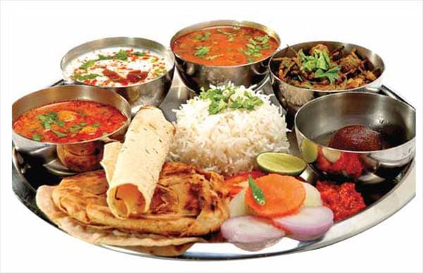 Traditional Bundelkhandi thali with dal, seasonal vegetables and bafla breads in Orchha